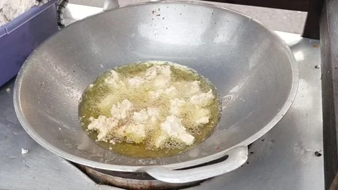 Video background frying pan with hot oil frying white flour street food Stock Footage 329167474
