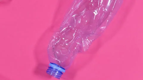 Video background of plastic bottles isolated on pink background. Recycle waste Stock Footage 276139124