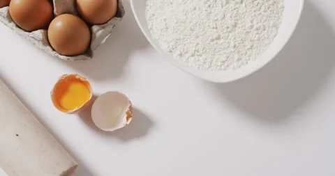 Video of baking ingredients and tools lying on white surface Stock Footage 341088637