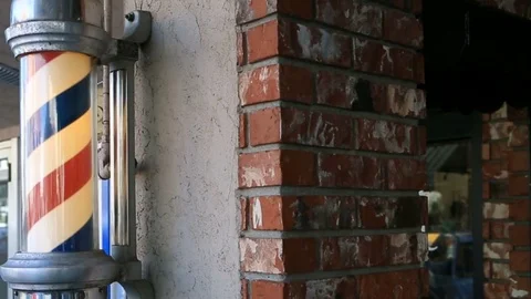 Video of a Barber's pole with a revolving helix stripes of colors trade sign Stock Footage