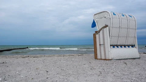 Video of beach chairon white sand at windy cloudy weather at Baltic sea in Ge Stock Footage 134329087