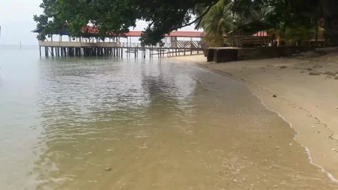 Video of a beach view with crashing waves and white sand during the day Stock Footage 324354565