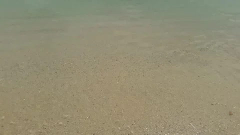 Video of a beach view with crashing waves and white sand during the day Stock Footage 324354968