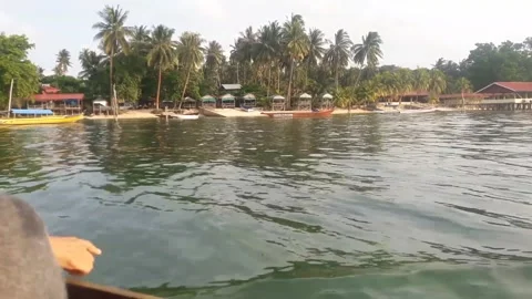 Video of a beach view taken from a small boat sailing during the day Stock Footage 324356090