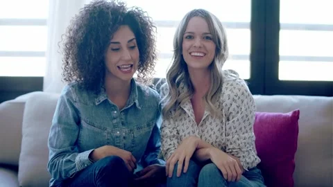 Video of beautiful couple explaing something looking at camera while doing vi Stock Footage 161085294