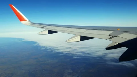 VIdeo of beautiful scattered clouds of the blue sky, view from the plane window Stock Footage 166313759