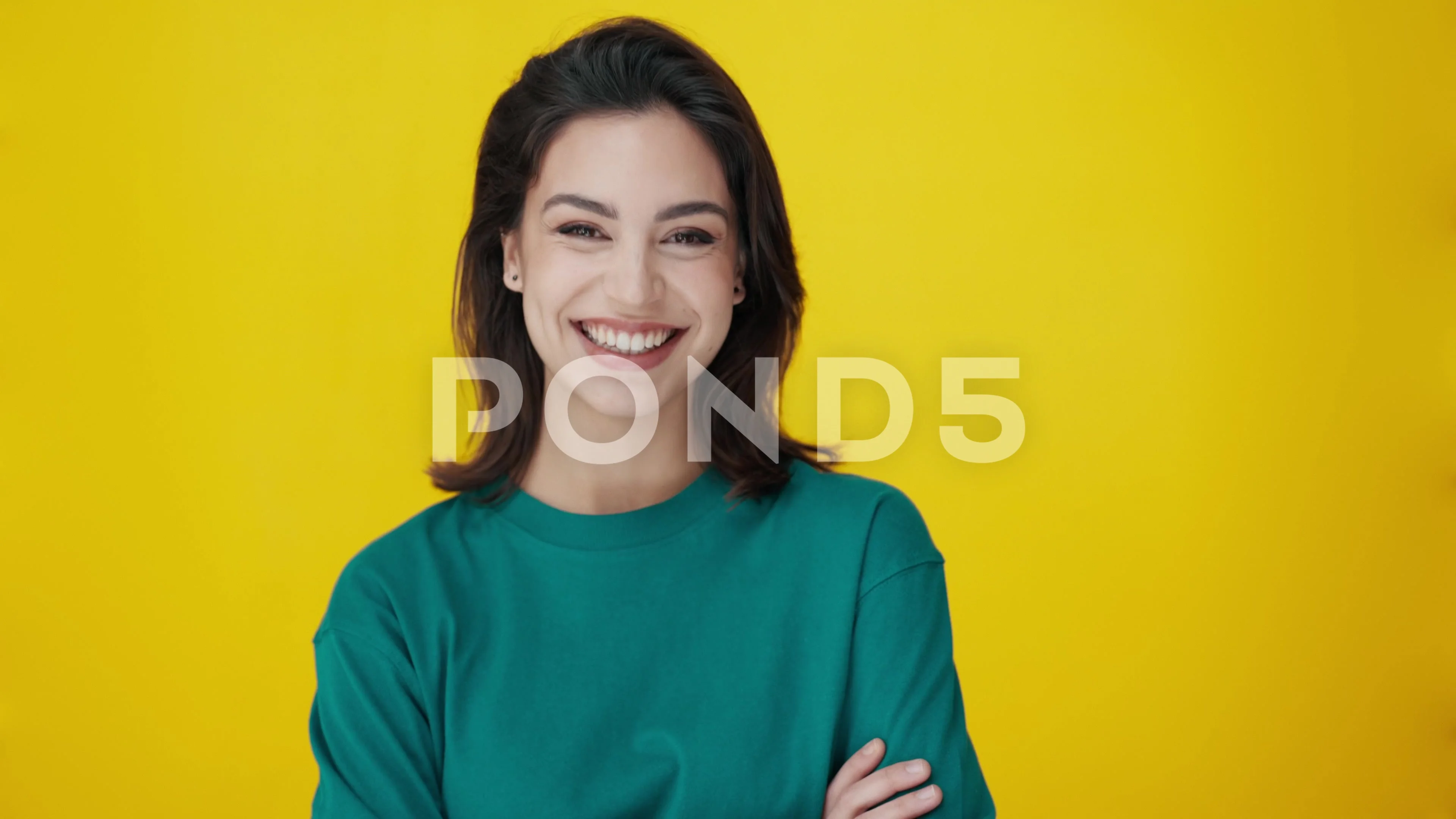 Video of beautiful woman smiling while looking at camera on isolated on  yello