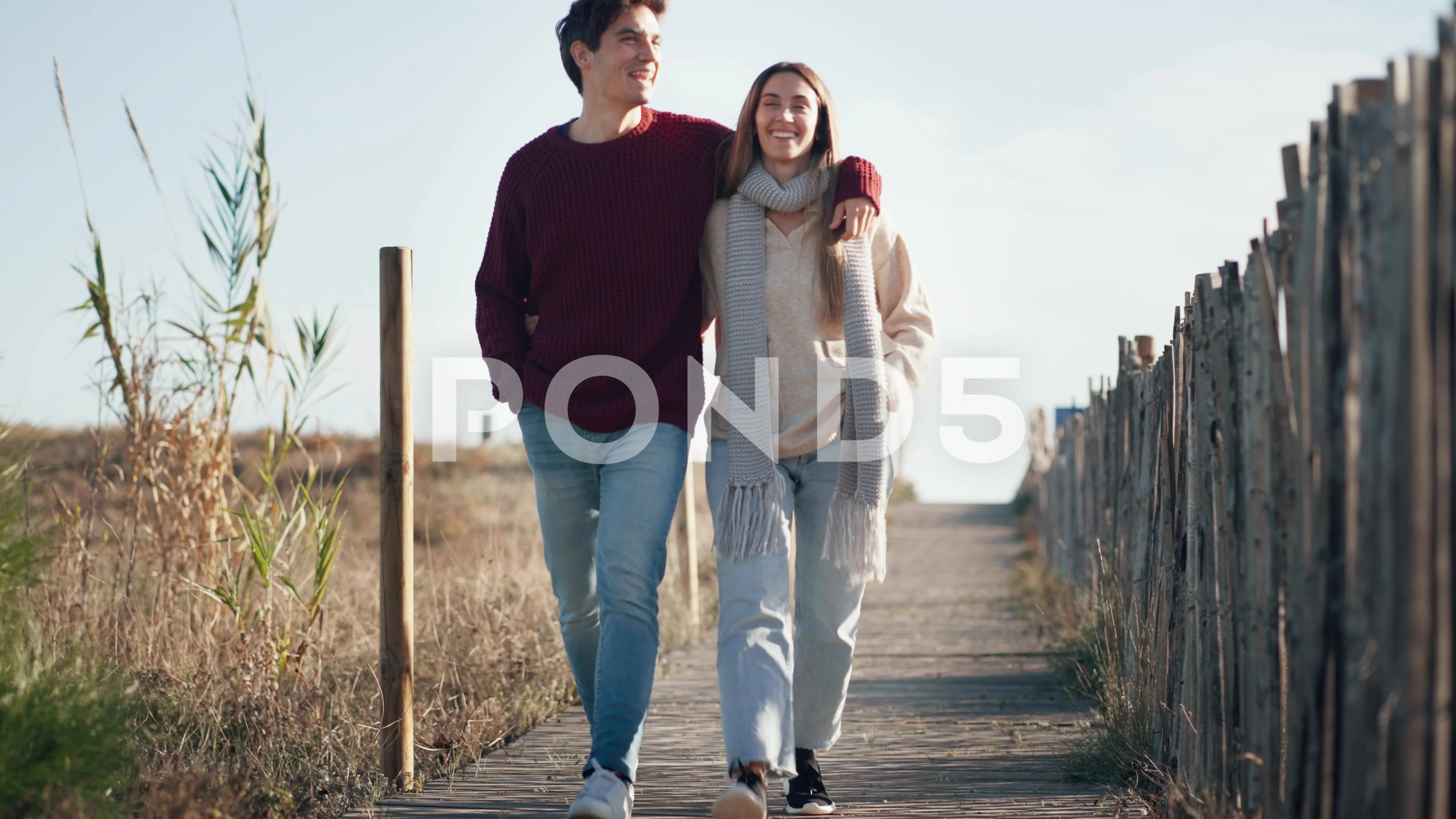 Video of beautiful young couple in love walking together in a cold winter  d..