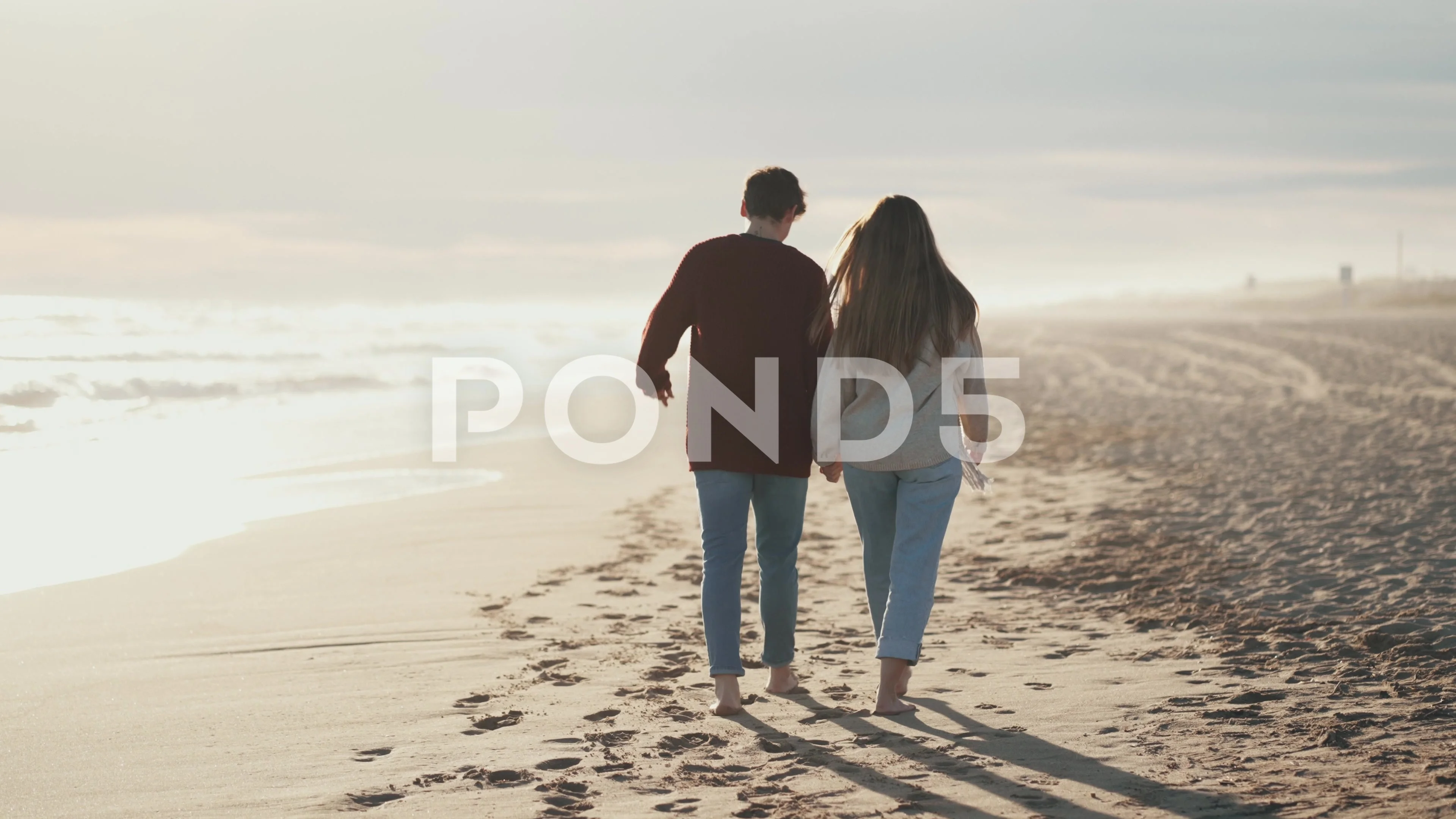 Video of beautiful young couple in love walking together in a cold winter  d..