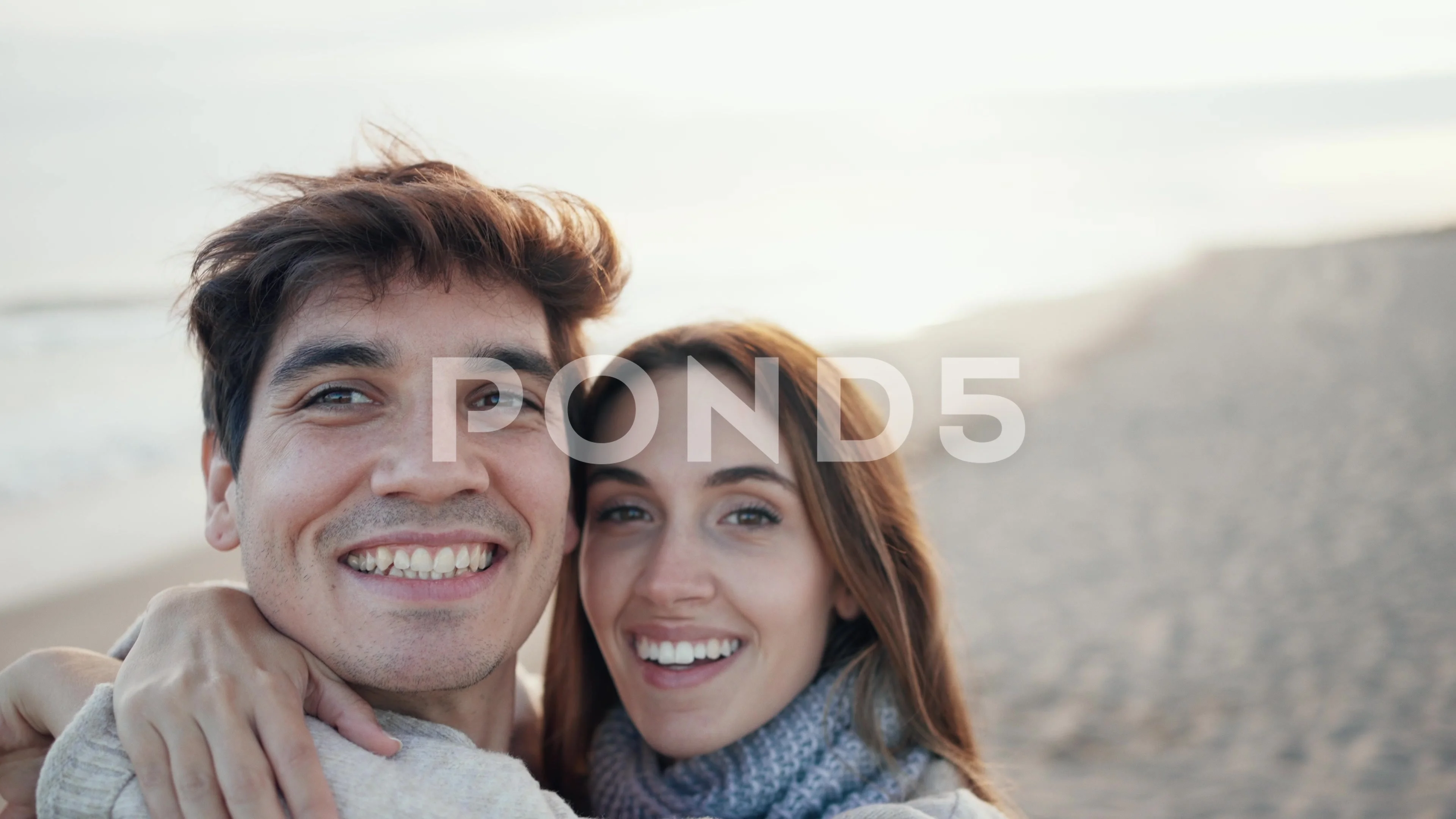 Video of beautiful young couple making photos with mobile phone in a cold  w..