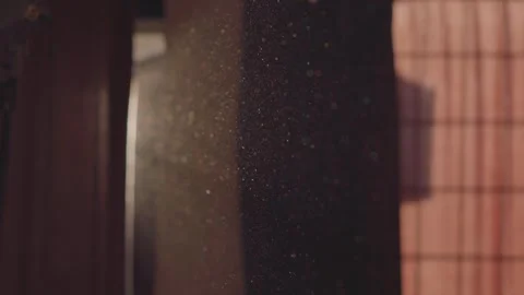 A video of beautifully moving particles in the air in a dark room, appearin.. Stock Footage 335837697