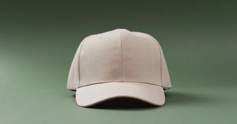 Video of beige baseball cap and copy space on green background 스톡 동영상 247354481