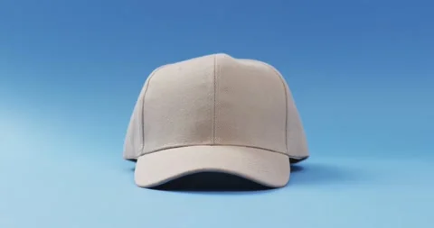 Video of beige baseball cap and copy space on blue background 스톡 동영상 247354491