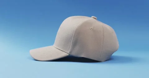 Video of beige baseball cap and copy space on blue background 스톡 동영상 331246423