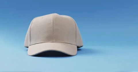 Video of beige baseball cap and copy space on blue background 스톡 동영상 331295205