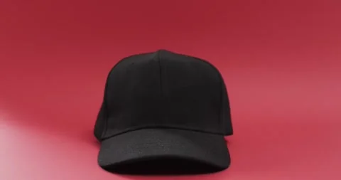 Video of black baseball cap and copy space on red background 스톡 동영상 247354471