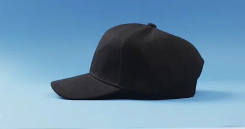Video of black baseball cap and copy space on blue background 스톡 동영상 247354501