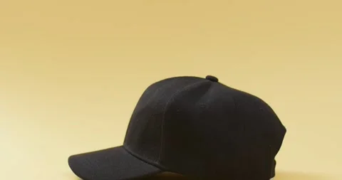 Video of black baseball cap and copy space on yellow background 스톡 동영상 331208613