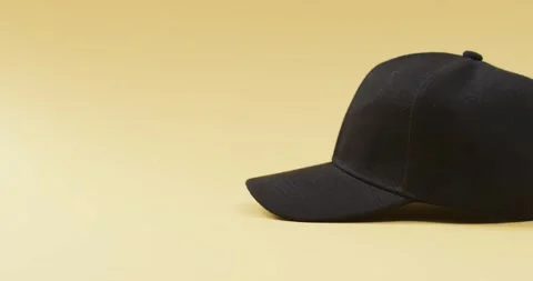 Video of black baseball cap and copy space on yellow background 스톡 동영상 331208619