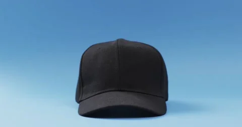 Video of black baseball cap and copy space on blue background 스톡 동영상 331307306