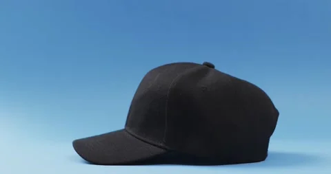 Video of black baseball cap and copy space on blue background 스톡 동영상 331358742