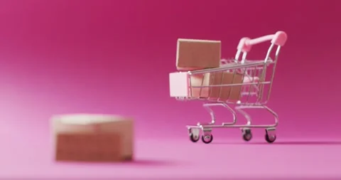 Video of black friday text on cardboard and boxes in shopping trolley on pink Stock Footage 331306963