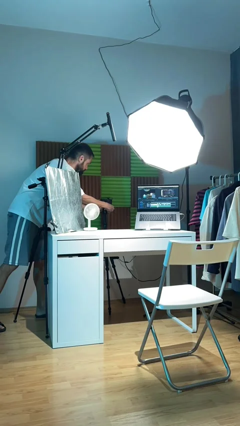 A video blogger prepares a table in a studio for video recording and sets up Stock Footage 280305108
