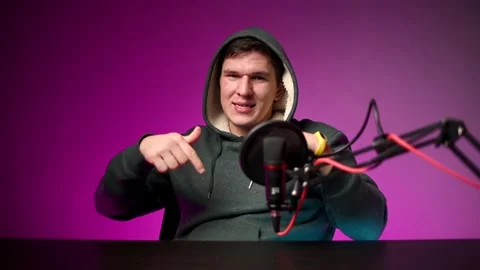 Video blogger speaks into the microphone in front of the camera. Stock Footage 141504729