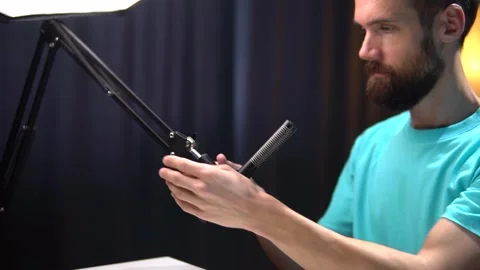 A video blogger in the studio adjusts the optimal position of the microphone Stock Footage 279377635