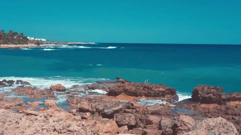 Video of blue sea waves hitting the big stones Stock Footage 211175345