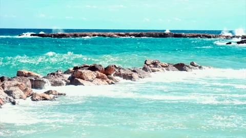 Video of blue sea waves hitting the big stones Stock Footage 211175429
