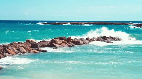 Video of blue sea waves hitting the big stones Stock Footage 211175483