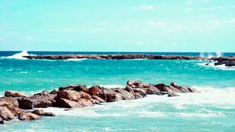 Video of blue sea waves hitting the big stones Stock Footage 211175509