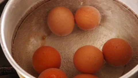 Video of boiling eggs in a pot (close-up). Food preparation concept. Stock Footage 231541138