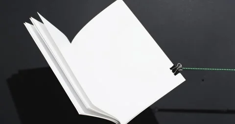 Video of book with string and white blank pages and copy space on black Stock Footage 256912897