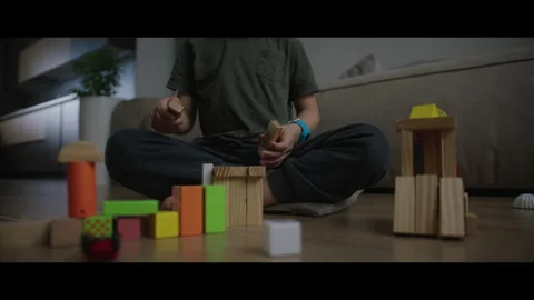 Video of a boy and a man bonding, building block structures happily Stock Footage 276906555