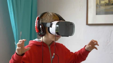Video of boy exploring virtual reality and playing games in slow motion 4k Stock Footage 86025641