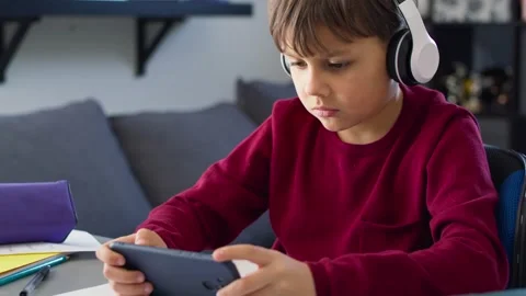 Video of boy playing on the phone during online classes. Stock Footage 149253692