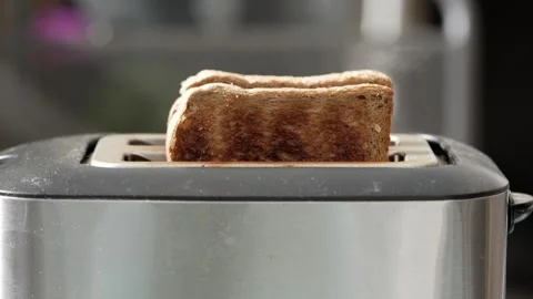 Video of bread slices toasting, showcasing the process of making toast Video stock 273983357