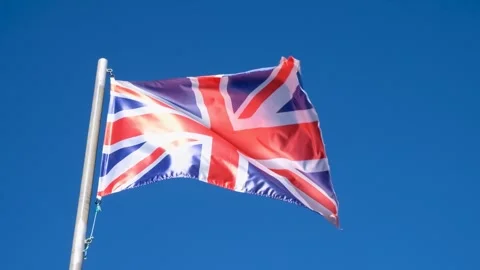 A video of the british flag on a flagpole against a clear blue sky national.. 스톡 동영상 314559982