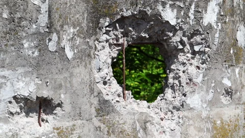 Video of a broken cement wall. Stone grunge odd wall with a hole. Hole in the Stock Footage 245949399