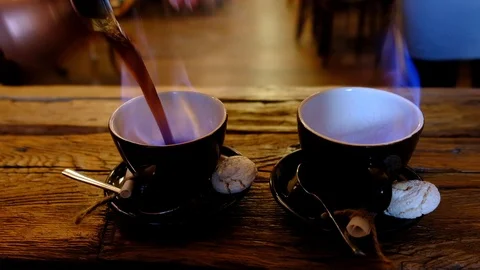 Video of burning coffee cups and pouring turkish coffee from copper cezve. Co Stock Footage 123407892