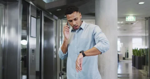 Video of businessman using smartphone and checking watch Stock Footage 344849603