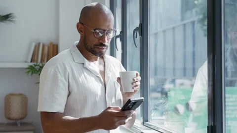 Video of businessman using smartphone while drinking a coffee standing near.. Stock Footage 321243227