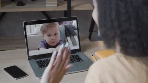 Video call and chat concept. multiracial woman on a video call with a child Stock Footage 134898692