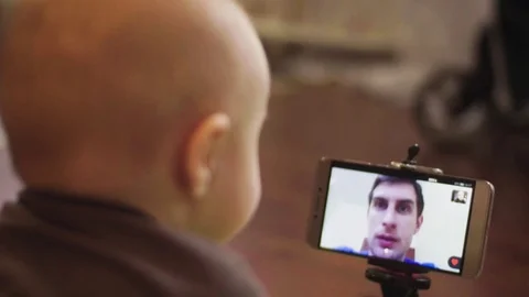 On video call communicate with father with a small child Stock Footage