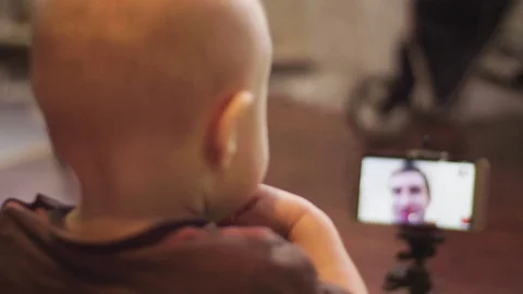 On video call communicate with father with a small son Stock Footage 84575684