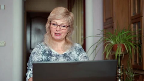 Video call concept technologies, elderly woman 55s with nice wrinkles smiling Stock Footage 152726495