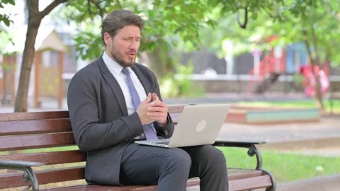 Video Call on Laptop by Middle Aged Businessman Outdoor Video stock 313584616