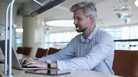 Video call, man with headset and tablet computer looking at camera. Stock Footage 340067715